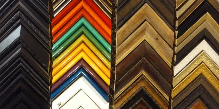 Colorful custom frame moulding samples arranged in a chevron pattern